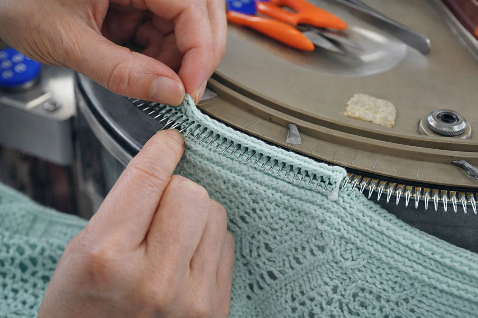 Linking machine close-up detail knitwear stitching