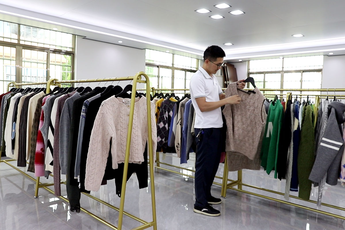 Lin Sweater Factory sample room — finished knitwear styles on display for buyers